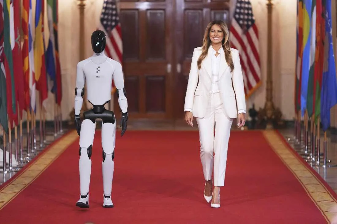 Melania Trump joins robot at tech event.